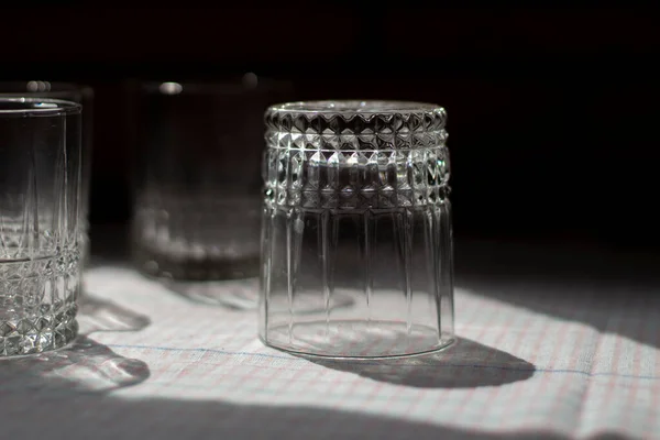 Glass beakers. Transparent glass on the table. Dishes in the kitchen. Washed glasses.