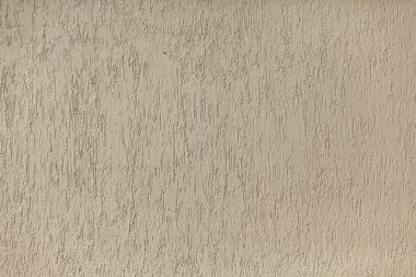 Duvar dokusu. Sert bir yüzey. Boyalı bir duvarda bej renkler.