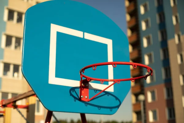 Basketball hoop on the sports ground. Ball ring. Sports equipment in the yard. Basketball on the street.