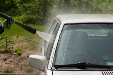 Araba yıkamada yıkanır. Arabayı çamurdan yıkıyorum. Araba yıkamak için yüksek basınçlı su püskürtme ekipmanı.