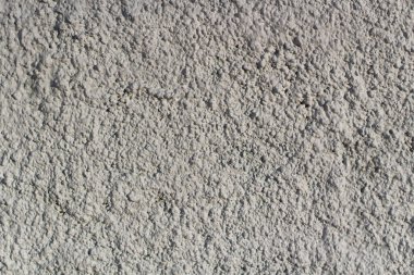 Duvarın kaba dokusu. Duvar caddede. Yüzey beyaz. Arkaplan yakın plan.