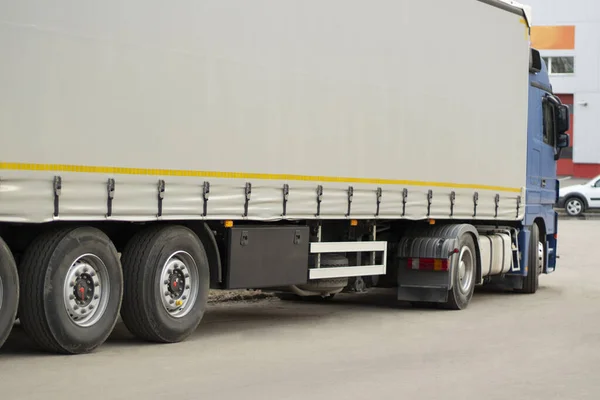 Truck wheels. Transportation of goods in freight transport. Lots of big wheels. Awning on a truck.