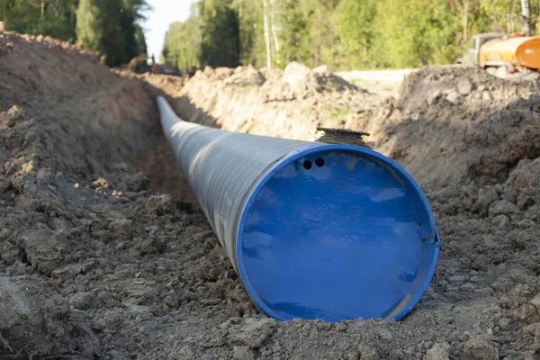 A big pipe for oil. The pipe burrows into the ground. Industrial transport of fuel. Laying communications. Digging into the ground infrastructure.