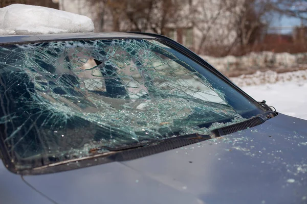 Broken car glass. The windshield cracked. Damaged transport. The car is in the parking lot broken.