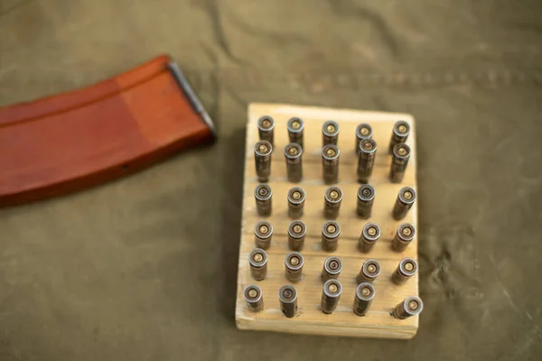 Cartridges from firearms. Cartridges on the training stand. Soviet automatic weapons in detail. A box for cartridges with sleeves.