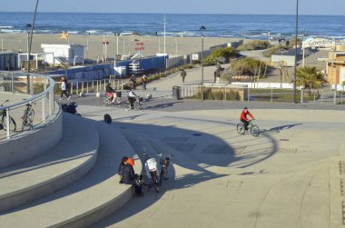 İtalya, COVID-19 'un ortasında Kırmızı Bölge altında. 23 Mart 2021, Rimini, İtalya: İtalya 'nın kuzeyindeki Emilia-Romagna bölgesine ait insanların Rimini' deki Parque Del Mare 'den geçişi. Yeri Paskalya 'dan sonra bile kırmızı bölgede kalacak.