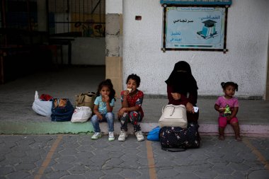 Israeli-Palestinian conflict. May 18, 2021. Rafah, Gaza, the Palestinian Territories: Displaced Palestinian families with their belongings to schools belonging to the United Nations Relief and Works Agency for Palestine Refugees (UNRWA) clipart