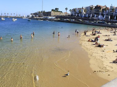 Bathers movement on Ribeira beach, in Cascais. July 29, 2021, Cascais, Portugal: Sunny day with pleasant temperature takes bathers to Ribeira beach, which is in center of Cascais, in metropolitan region of Lisbon, on Thursday (29).  