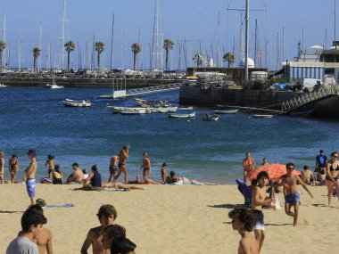 Bathers movement on Ribeira beach, in Cascais. July 29, 2021, Cascais, Portugal: Sunny day with pleasant temperature takes bathers to Ribeira beach, which is in center of Cascais, in metropolitan region of Lisbon, on Thursday (29).  
