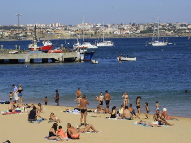 Bathers movement on Ribeira beach, in Cascais. July 29, 2021, Cascais, Portugal: Sunny day with pleasant temperature takes bathers to Ribeira beach, which is in center of Cascais, in metropolitan region of Lisbon, on Thursday (29).  