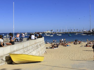 Bathers movement on Ribeira beach, in Cascais. July 29, 2021, Cascais, Portugal: Sunny day with pleasant temperature takes bathers to Ribeira beach, which is in center of Cascais, in metropolitan region of Lisbon, on Thursday (29).  