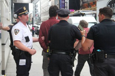  NYPD arrest a man who shouts shame on you at naked entertainers at Time Square. July 29, 2021, New York, USA: A man who was shouting shame on you at naked female entertainers and cowgirl for their exposition at Times Square 