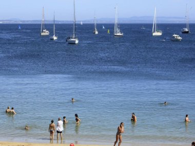 Cascais 'deki Rainha plajı. 31 Ağustos 2021, Cascais, Portekiz: Banyocular 31 Ağustos Salı günü Lizbon 'un başkenti Cascais' in kumsalındaki Rainha plajında güneşli bir günün tadını çıkarıyorlar.),