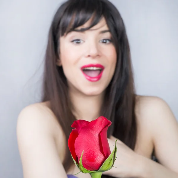 Menina surpresa e uma rosa Imagem De Stock