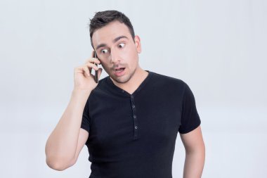 Bir cep telefonu üzerinde şaşırmış adam