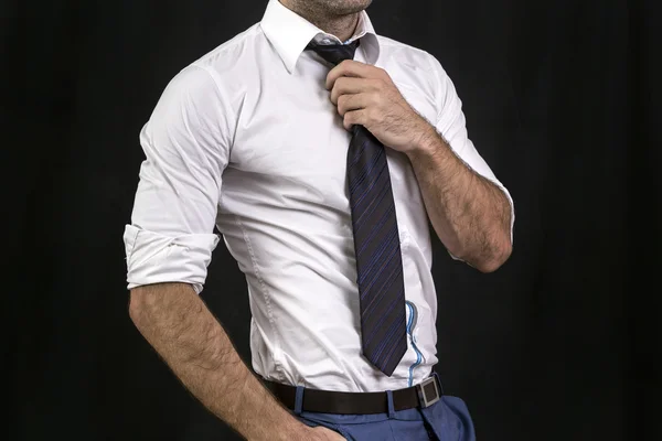 Businessman holding his tie — Stock Photo, Image