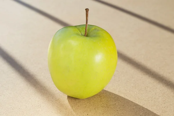 Green apple in the sunlight — Stock Photo, Image