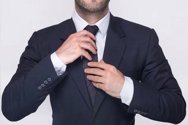 Man adjusting a tie — Stock Photo, Image