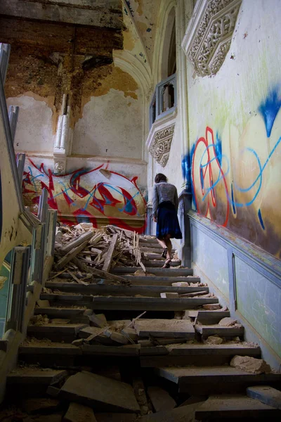 Girl on the stairs of an abandoned castle. Miranda Castle (Noisy castle)