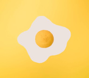 Yellow lemon on white and yellow paper. Minimal scrambled eggs design.