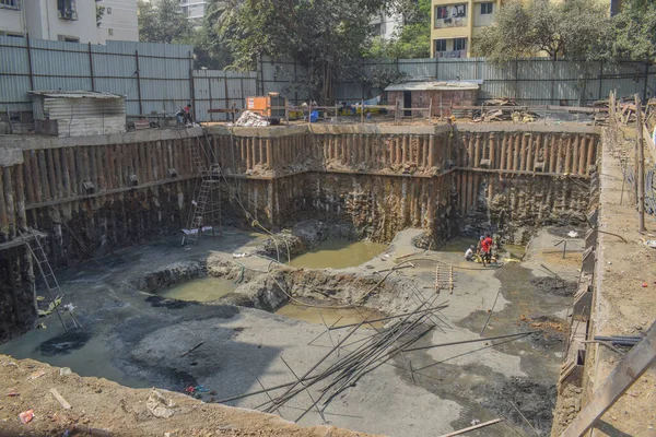 pile foundation in series at construction site with pot hole and water .Foundation for lift room and staircase and basement