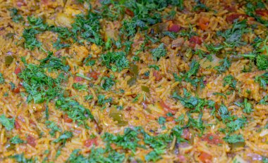 Biryani (biryani, birani, birani veya briyani olarak da bilinir) kişniş yapraklarıyla süslenmiş biryani