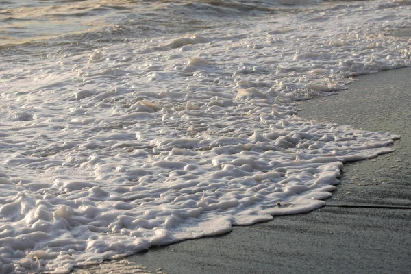 Vitt havsskum nära stranden närbild, vågor — Stockfoto