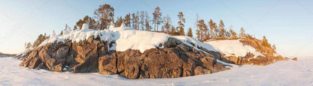 Winter, stony snow-covered island of Ladoga lake. A winter lands