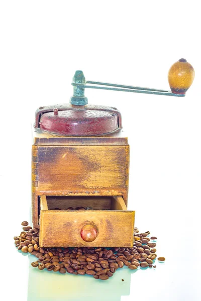 Old coffee grinder with beans on white background — Stock Photo, Image