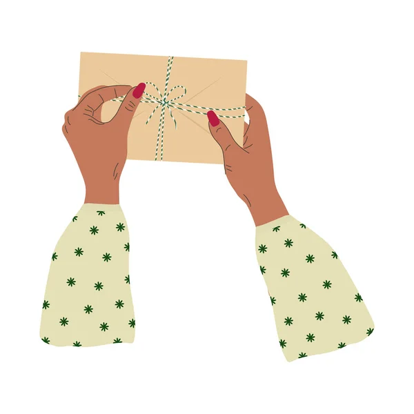 Händerna Håller Ett Kuvert Med Ett Rep Och Båge Trendig — Stock vektor