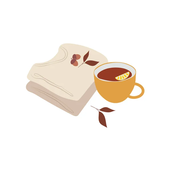 Katlanmış kazaklar, limonlu bir fincan çay, yapraklar ve meşe palamudu kompozisyonu.