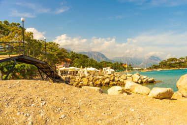 KEMER, TURKEY: güneşli bir günde Kemer plajında kanal yakınında küçük bir köprü görüntüsü.