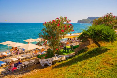 KEMER, TURKEY: Türkiye 'nin Akdeniz kıyısındaki popüler turistik beldesi Kemer' de güneşli bir günde plajın güzel manzarası.