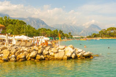 KEMER, TURKEY: Türkiye 'nin Akdeniz kıyısındaki popüler turizm beldesi Kemer' de güneşli bir günde Kemer 'deki ünlü Qualista Plajı.