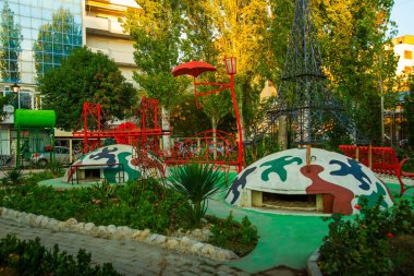 VLORA/VLORE, ALBANIA: Colorful bunkers have become the decoration of the yard. clipart