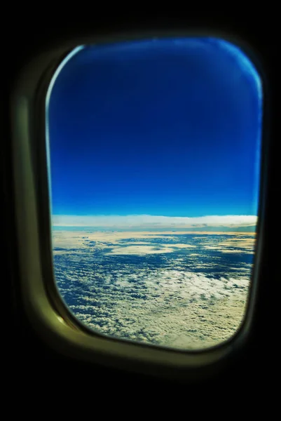 View from a jet plane window high on the blue skies. Beautiful landscape.