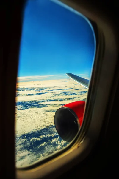 View from a jet plane window high on the blue skies. Beautiful landscape.