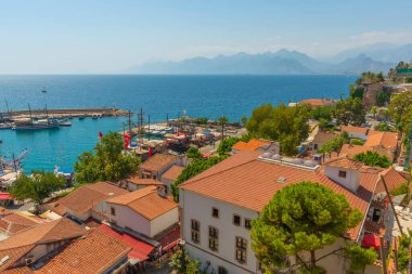 ANTALYA, TURKEY: Güneşli bir yaz gününde Antalya 'daki eski limanın ve limanın gemi ve tekneli üst manzarası, Türkiye.