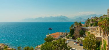 Antalya, Türkiye 'de güneşli bir yaz gününde eski kentin, denizin ve dağların güzel manzarası.