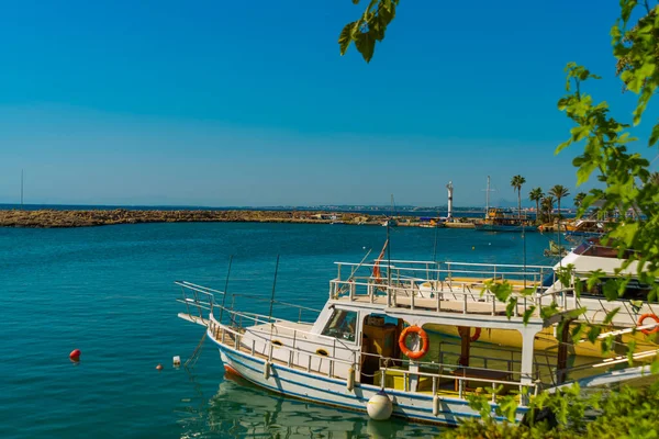 SIDE, TURKEY: Boats are moored at the pier in the ancient city of Side on a sunny summer day, Turkey.