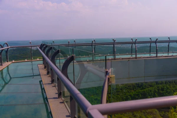 stock image SATAPLIA, KUTAISI, IMERETI, GEORGIA: View to glass bottomed observation platform with clear floor at highest point of state Sataplia reserve with wonderful view of Kutaisi and Its surroundings.