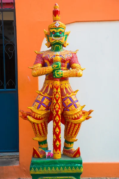 Multi-colored sculpture of a warrior with a sword with a green face at a Buddhist temple. Nakhon Ratchasima. Thailand. — Stock Photo, Image