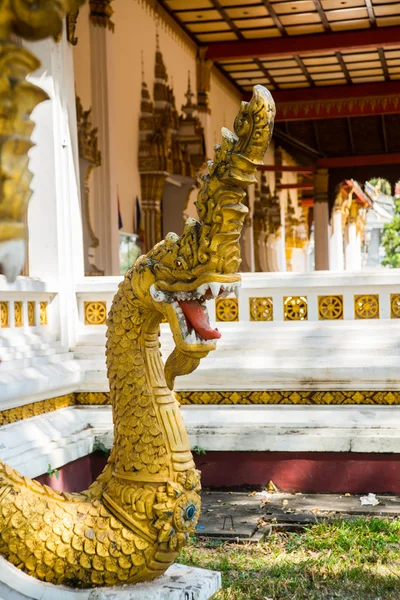 Golden dragon with open mouth.Sculpture at the temple. Laos, Vientiane. — Stock Photo, Image