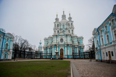 Smolny Cathedral in overcast weather in St. Petersburg,Russia.The temple is blue with white columns and decor. clipart
