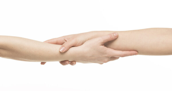 Two female hands holding on each other at the wrists