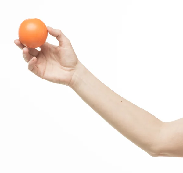 Main féminine avec boule d'éponge orange — Photo