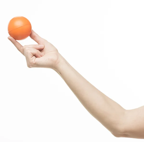 Female hand with orange sponge ball — Stock Photo, Image