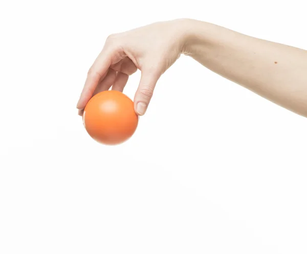 Mão feminina com bola de esponja laranja Fotografia De Stock