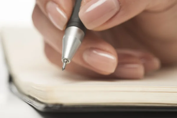 Escritura a mano femenina en cuaderno Imágenes de stock libres de derechos