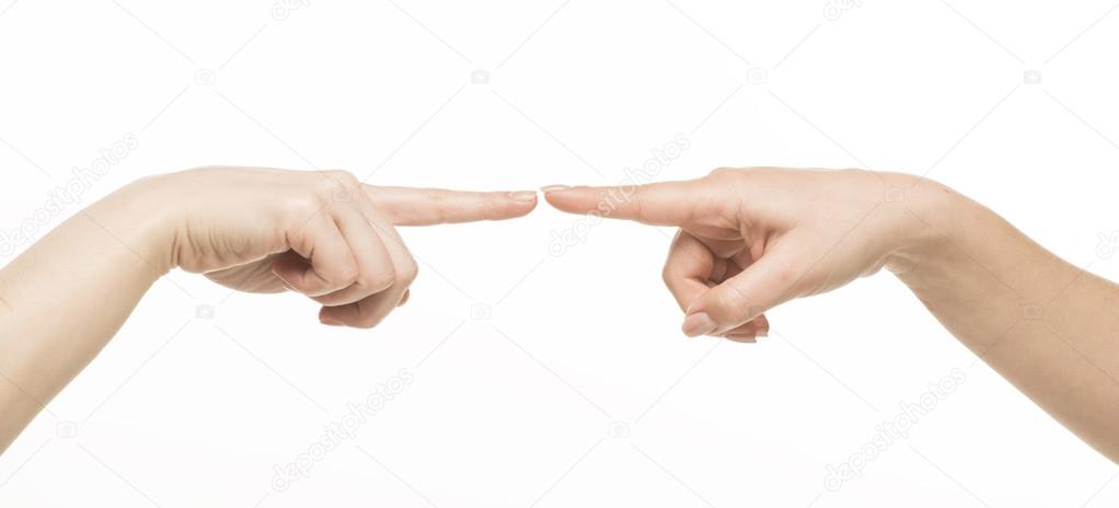 Two different female hands touching each other by index finger